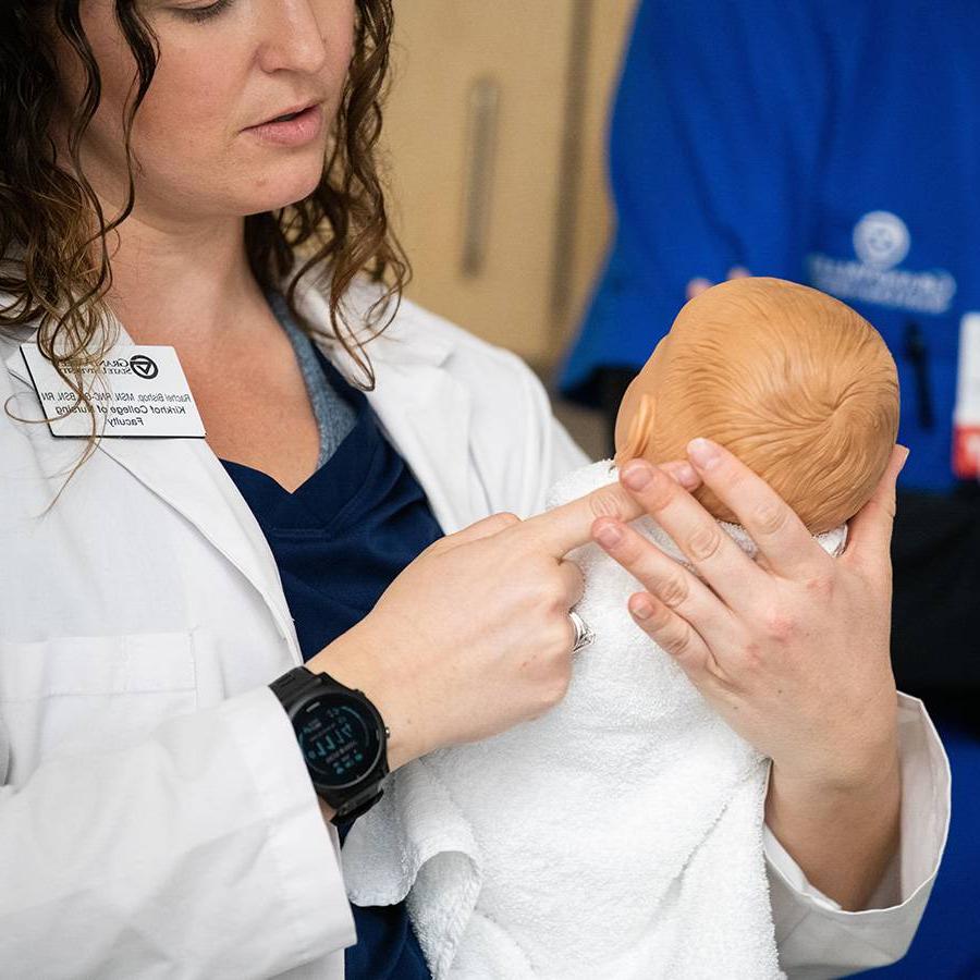 DNP students with a baby manikin